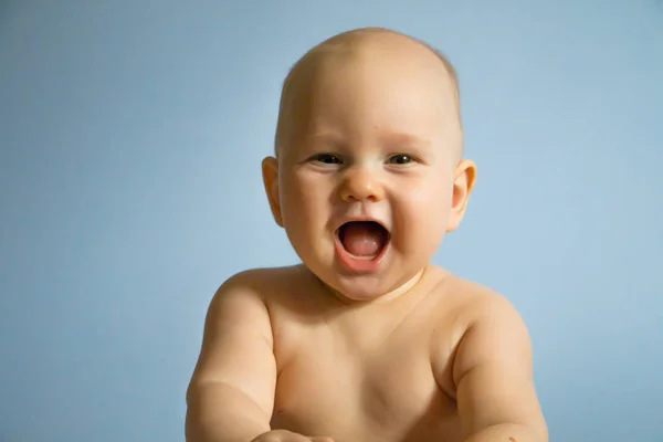 Hermoso retrato de cerca de un bebé feliz sobre un fondo uniforme — Foto de Stock