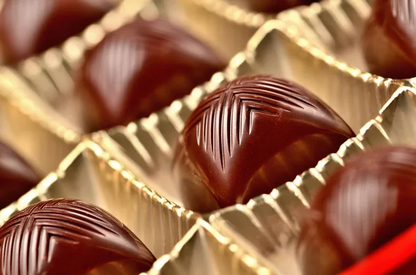 Close-up of cherry chocolate in box of chocolates with a creamy filling liquor — Stock Photo, Image