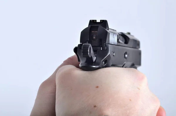 Hand aiming with pistol - view through the pistol sight — Stock Photo, Image