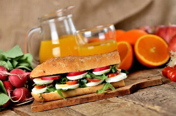 Baguette sandwich with egg, arugula salad, tomatoes and radish — Stock Photo, Image