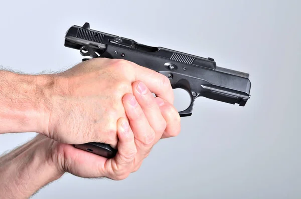 Ruka muže s pistolí - boční pohled — Stock fotografie
