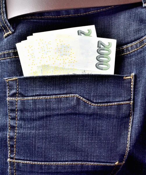 Czech banknotes in the back pocket of jeans with belt, thousand, two thousand Czech crowns