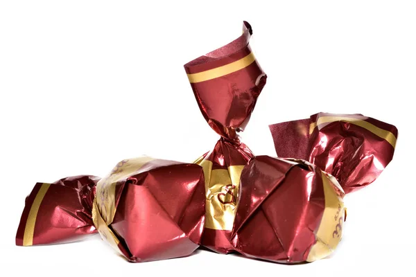 Chocolate candies wrapped in shiny ornamental wrapping — Stock Photo, Image