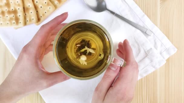 Green Tea Jasmine Brewed Leaves Move Cup Circle Female Hands — Stock Video