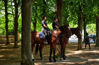 Berlin, Almanya - 8 Mayıs 2020: Brandenburg Kapısı yakınlarındaki Tiergarten 'de bir kadın ve bir erkek polis memuru.