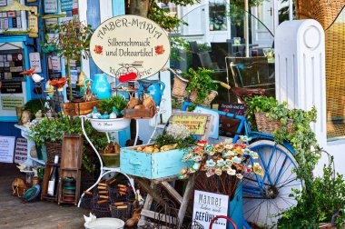 Bansin, Germany - September 13, 2019: Small souvenir shop with hundreds of keepsakes on the promenade of Bansin, Germany, on the holiday island of Usedom in the Baltic Sea. clipart