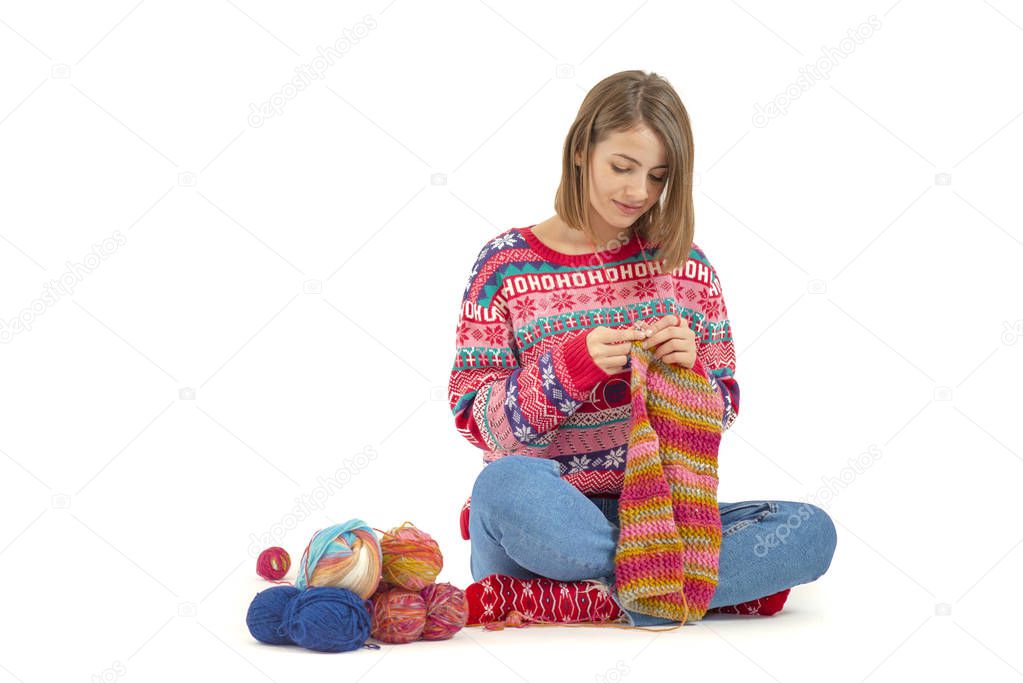 Young woman knitting isolated on white background