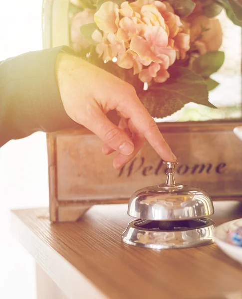 Hand ringing in service bell at hotel