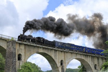 Miyamori bridge and steam locomotive in Tono, Iwate, Japan clipart