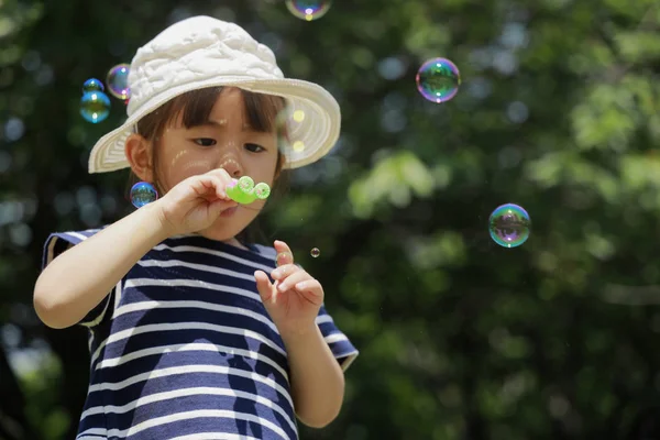 Ragazza giapponese che gioca con bolla sotto il cielo blu (4 anni ) — Foto Stock