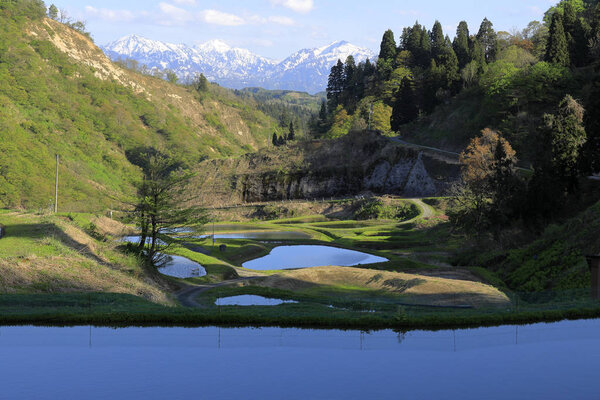 terraced rice field and Echigo mountains in Yamakoshi, Nagaoka, Niigata, Japan