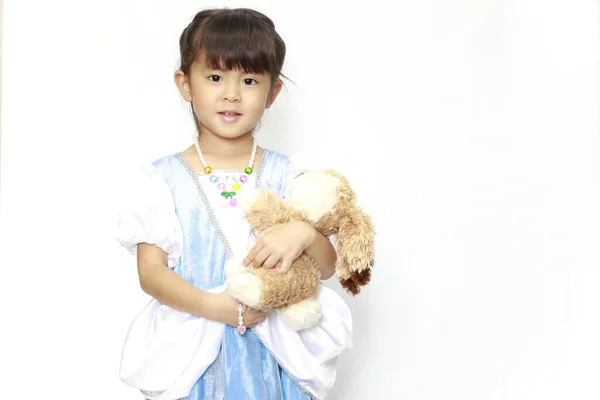 Japanese girl in a dress holding a stuffed rabbit (4 years old) — ストック写真