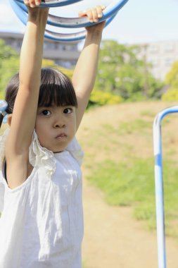 Japon kız maymun parmaklıklarıyla oynuyor (5 yaşında))