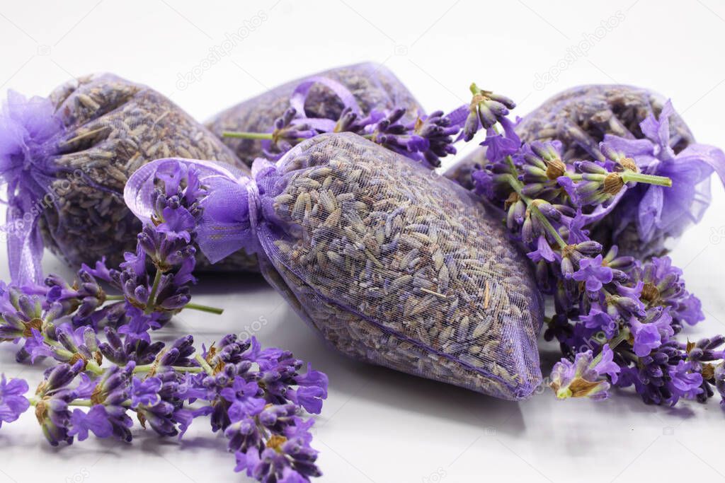 Close up of isolated bagged dried lavender blossom sacs used as moth repellent in wardrobe for clothes protection, white background