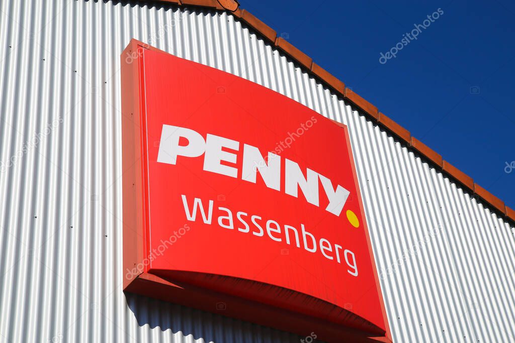 Wassenberg, Germany - March 23. 2020: Close up of isolated sign of german Penny food discounter chain against clear blue sky