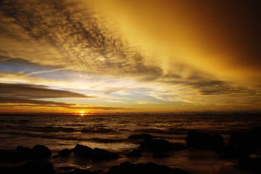Şiddetli yağmurdan sonra gün batımı. Arcus raf bulutları ve taşlarla okyanusta tropikal ada Ko Lanta, Tayland