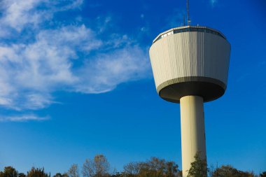 View on isolated 55 meter high water tower through against blue sky. Tower function as reservoir for 2000 cubic meter water. Viersen,Duelken), Germany clipart