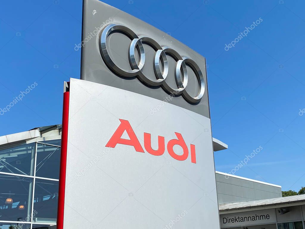 Viersen, Germany - 23. June 2020: View on isolated Audi lettering and logo sign against blue sky