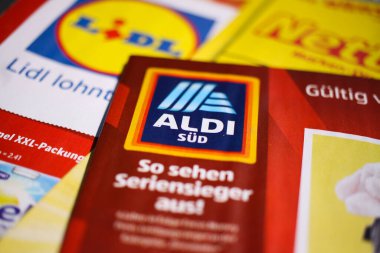 Viersen, Germany - July 27. 2020: Makro closeup of weekly printed advertising inserts from german discounter companies clipart