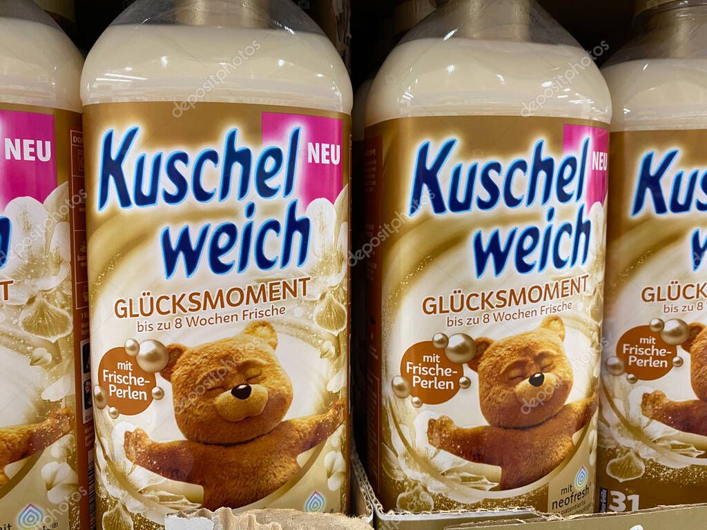 Viersen, Germany - July 9. 2020: Closeup of isolated bottles Kuschelweich fabric softener in shelf of german supermarket