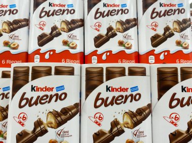 Viersen, Germany - July 9. 2020: View on stack Kinder Bueno chocolate bar boxes in shelf of german supermarket (focus on lower row) clipart