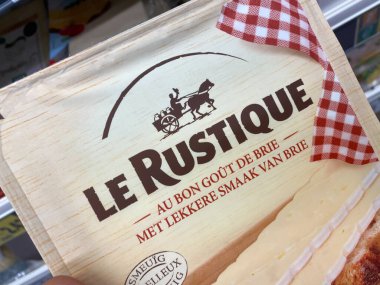 Viersen, Almanya - 9 Temmuz. 2020: Alman süpermarketinin rafında elle tutulan Le Rustique camembert peyniri paketinde görüntüle (paket merkezine odaklan)