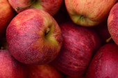 Detailní záběr a pozadí čerstvých červených jablek vedle sebe na trhu