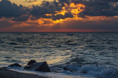 Sahilde ve denizde güzel bir gün batımı.