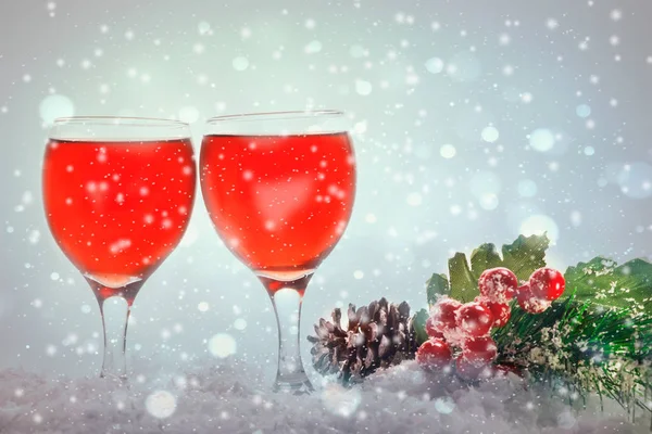 Red wine glasses and christmas balls on snow — Stock Photo, Image