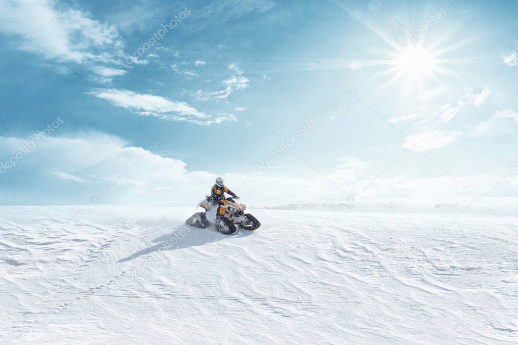 Man driving sports snowmobile in Finnish Lapland in a snow sunny day