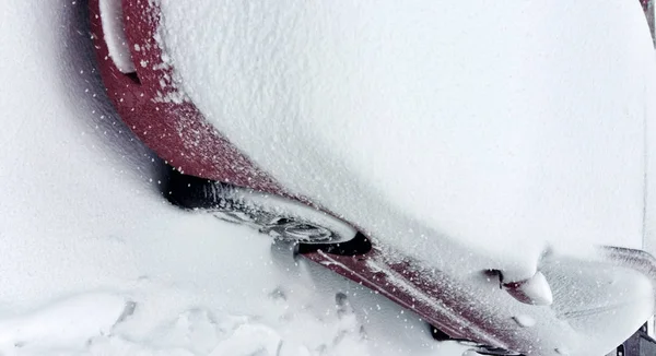 Winter tire. Car tire on snow road. Tires on snowy road detail.