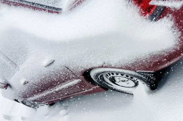 Winter tire. Car tire on snow road. Tires on snowy road detail.