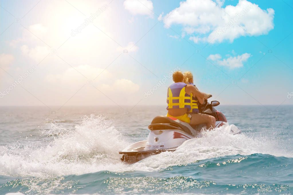 Tourists enjoy driving jetski on the ocean