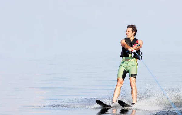 Closeup man riding water skis on lake in summer at sunny day. Water active sport. Space for text — Stock Photo, Image