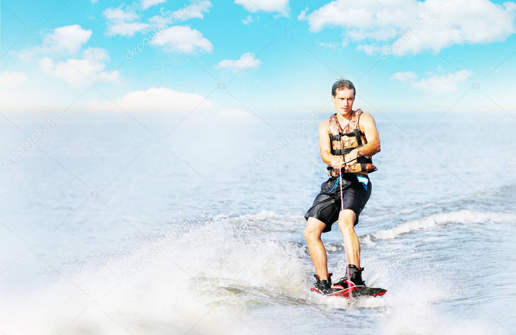 wakeboarder trains in the lake at sunny day. Space for text
