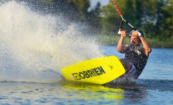 Cherkassy, Ukraine - July 19, 2019: Wakeboarder showing of tricks and skills at wakeboarding event in Cherkassy