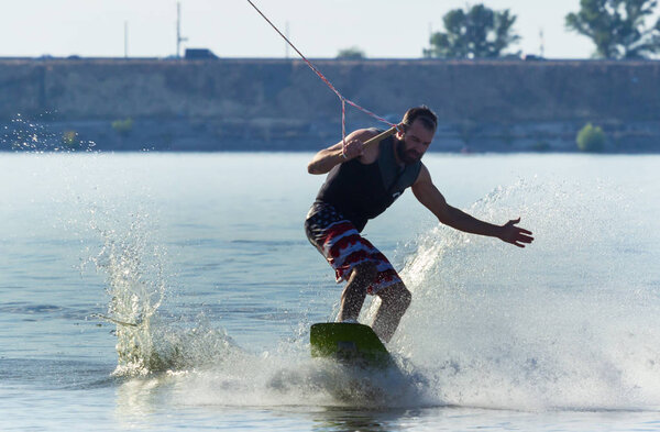 Cherkassy, Ukraine - July 19, 2019: Wakeboarder showing of tricks and skills at wakeboarding event in Cherkassy