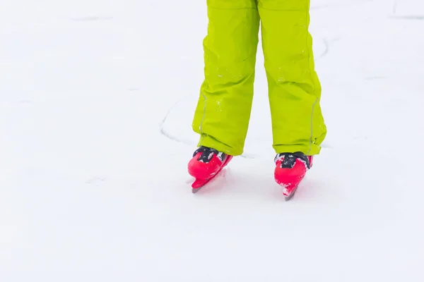 Red ice skates on frozen lake — Stock Photo, Image