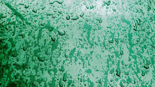 Mint colored holiday glitter background. Blurred festive green backdrop for your design. Holiday concept, new year celebration. Midnight green colored. Water drop