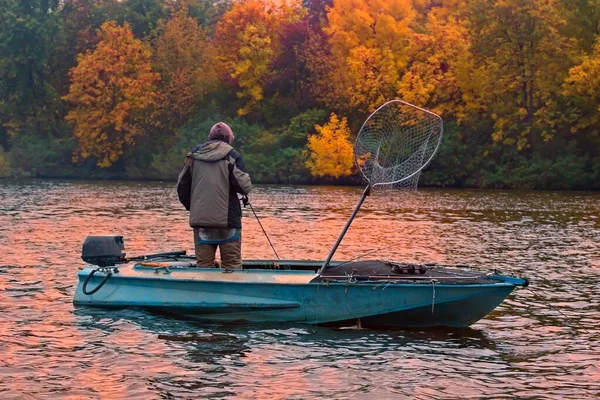 Fishing rod on the boat, sunset time. Beautiful autumn colors. A fishing rod is a long, flexible rod used by fishermen to catch fish. — Stock Photo, Image