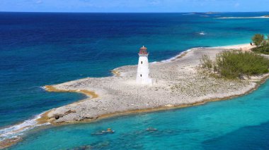 Turkuaz rengi mükemmel, Bahamalar limanındaki mavi sularda küçük bir gemi yüzüyor.