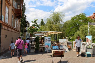 Ljubljana, Slovenya - 16 Temmuz 2018: Slovenya 'nın Ljubljana kentindeki Ljublijanica Nehri kıyısındaki bir sokakta bir sanatçı tezgahı