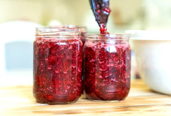 Pour the raspberries and sugar. cover with a lid and store in the refrigerator — Stock Image Pour the raspberries and sugar. cover with a lid and store in the refrigerator Royalty Free Stock Images