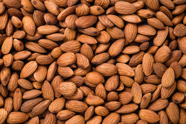 Top view of fresh raw peeled almonds nut for background.
