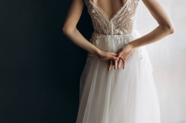 Beyaz gelinlikli gelin siyah beyaz arka planda narin elleri tutuyor. mesaj için yer. Gelinin zarif elleri