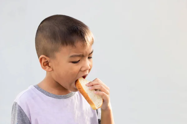Little Asian Child Boy Eating Bread White Background Breakfast Meal — Stock Photo, Image