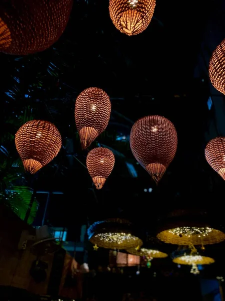 stock image Beautifully lit straw lanterns hanging from the top