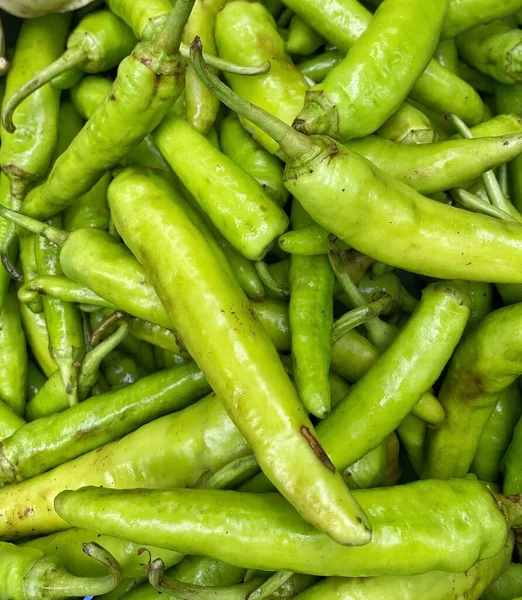 Fresh Indian green chillies stacked up in a market