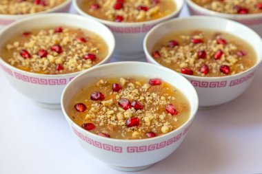 Turkish dessert Asure, Noah's pudding, with pomegranate seeds and walnut clipart