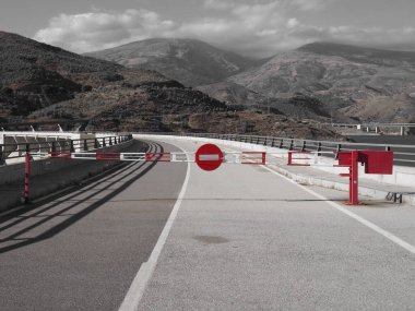 Kapalı bir yolda kırmızı ve beyaz bariyerli